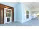 Inviting covered front porch featuring the door to the home at 7435 Redwing Rd, Groveland, FL 34736