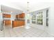 Bright eat-in kitchen featuring tile flooring, light wood cabinetry, and large bay window at 7435 Redwing Rd, Groveland, FL 34736