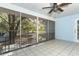 Screened lanai with ceiling fan overlooking the backyard at 7435 Redwing Rd, Groveland, FL 34736