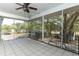 Screened lanai with ceiling fan overlooking the lush backyard at 7435 Redwing Rd, Groveland, FL 34736