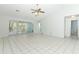 Spacious living room features tile flooring, sliding glass doors, and neutral paint at 7435 Redwing Rd, Groveland, FL 34736