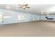 Bright living room with windows, carpet, and open layout at 7435 Redwing Rd, Groveland, FL 34736