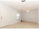 Open living room features ceramic tile floors and a white front door with sidelight at 7435 Redwing Rd, Groveland, FL 34736