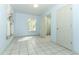 Bright Living room with tiled floor, window and two white doors to bathroom and bedroom at 7435 Redwing Rd, Groveland, FL 34736