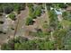 Aerial view of a sprawling property with mature trees and defined boundaries, offering a serene, expansive setting at 7435 Redwing Rd, Groveland, FL 34736