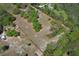 Aerial view with property lines highlighting a large parcel of land with mature trees in a tranquil, outdoor setting at 7435 Redwing Rd, Groveland, FL 34736