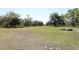 Wide angle view of grass-covered, rectangular-shaped homesite with mature trees at 7435 Redwing Rd, Groveland, FL 34736