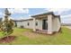 Private backyard with a cozy patio area, ideal for outdoor relaxation and entertaining at 800 Griffon Ave, Lake Alfred, FL 33850