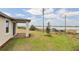 Expansive backyard with covered patio area offering stunning waterfront views at 800 Griffon Ave, Lake Alfred, FL 33850