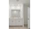 Bright bathroom featuring a double sink vanity and a large mirror at 800 Griffon Ave, Lake Alfred, FL 33850
