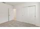 Bedroom featuring neutral carpet, fresh white walls, double door closet, and natural light from window at 800 Griffon Ave, Lake Alfred, FL 33850