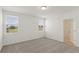 Bright bedroom with two windows and neutral carpet at 800 Griffon Ave, Lake Alfred, FL 33850