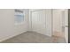 Bedroom with neutral carpet, fresh white walls, a double door closet and natural light from window at 800 Griffon Ave, Lake Alfred, FL 33850