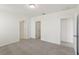 Open bedroom featuring neutral walls, neutral carpet and multiple entry points at 800 Griffon Ave, Lake Alfred, FL 33850