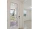 Home entryway featuring a glass front door and tile flooring leading to a bright, neutral interior at 800 Griffon Ave, Lake Alfred, FL 33850