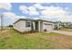 Stylish single-story home boasts a lush lawn, brick-paved driveway, and a two-car garage at 800 Griffon Ave, Lake Alfred, FL 33850