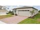 Charming one-story home features a two-car garage, brick driveway, and well-kept landscaping at 800 Griffon Ave, Lake Alfred, FL 33850