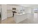 Modern kitchen featuring stainless steel appliances, a center island, and natural light from sliding glass doors at 800 Griffon Ave, Lake Alfred, FL 33850