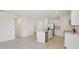 Bright kitchen featuring white cabinets, stainless steel appliances, and center island with sink at 800 Griffon Ave, Lake Alfred, FL 33850