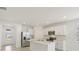 Modern kitchen featuring stainless steel appliances, white cabinetry, and center island at 800 Griffon Ave, Lake Alfred, FL 33850