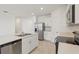 Contemporary kitchen with stainless steel appliances, white cabinets, and center island with sink at 800 Griffon Ave, Lake Alfred, FL 33850