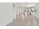 Bright, open-concept living space leading into the kitchen with white cabinetry and stainless appliances at 800 Griffon Ave, Lake Alfred, FL 33850