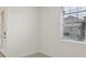 Bright, vacant room featuring a window with blinds and a light-colored tile floor at 800 Griffon Ave, Lake Alfred, FL 33850