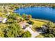 Aerial view of a beautiful home situated next to a serene lake, surrounded by lush greenery at 801 Springview Dr, Orlando, FL 32803