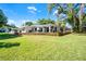 Expansive backyard featuring a modern home design with a large deck and lush green lawn at 801 Springview Dr, Orlando, FL 32803