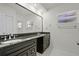 Bathroom featuring granite counters, dark cabinetry, and a large mirror at 801 Springview Dr, Orlando, FL 32803