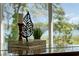 Detail shot of a piano with decorative items on top with a window lake view background at 801 Springview Dr, Orlando, FL 32803