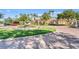 Charming clubhouse entrance with a decorative fountain, manicured lawn, and palm trees at 8338 Quimby Cir, Davenport, FL 33896