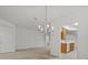 Inviting dining area adjacent to the kitchen featuring a modern chandelier and neutral walls at 8338 Quimby Cir, Davenport, FL 33896