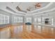 Bright exercise room featuring mirrored walls, ceiling fans, and hardwood floor at 8338 Quimby Cir, Davenport, FL 33896