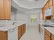 Bright kitchen boasting white countertops, wooden cabinets, and modern appliances at 8338 Quimby Cir, Davenport, FL 33896