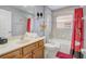 Charming bathroom featuring tub/shower combo, neutral tile, and fun Mickey Mouse decor at 1028 Orange Cosmos Blvd, Davenport, FL 33837