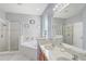 Relaxing bathroom features a large soaking tub, separate shower, and dual vanity sinks at 1028 Orange Cosmos Blvd, Davenport, FL 33837