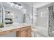 Well-lit bathroom featuring a vanity, tub/shower combo, and neutral tile at 1028 Orange Cosmos Blvd, Davenport, FL 33837