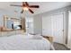 Comfortable bedroom featuring a ceiling fan, TV, and ample storage, perfect for relaxation and convenience at 1028 Orange Cosmos Blvd, Davenport, FL 33837