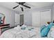 Inviting bedroom with plush bedding, ceiling fan, and ample natural light creating a restful atmosphere at 1028 Orange Cosmos Blvd, Davenport, FL 33837