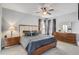 Comfortable bedroom with a stylish bed, ceiling fan, and a matching dresser and end tables at 1028 Orange Cosmos Blvd, Davenport, FL 33837