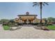 The community clubhouse features a fountain, tiled walkway, and a manicured green lawn at 1028 Orange Cosmos Blvd, Davenport, FL 33837