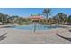 Upscale community pool featuring a brick-paved deck, palm trees, and comfortable lounge chairs at 1028 Orange Cosmos Blvd, Davenport, FL 33837