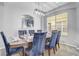 Elegant dining room with a large table set for a meal and view of kitchen at 1028 Orange Cosmos Blvd, Davenport, FL 33837