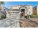 Charming two-story home boasts lush landscaping, a two-car garage and an arched entry at 1028 Orange Cosmos Blvd, Davenport, FL 33837