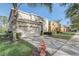 Beautiful two-story home with a two-car garage, manicured landscaping, and a long driveway at 1028 Orange Cosmos Blvd, Davenport, FL 33837