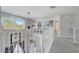 Bright hallway with staircase overlooking the first floor and a scenic view from the large window at 1028 Orange Cosmos Blvd, Davenport, FL 33837