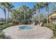 Community hot tub with two chairs, surrounded by beautiful landscaping at 1028 Orange Cosmos Blvd, Davenport, FL 33837