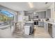 Spacious kitchen featuring modern appliances, gray cabinets, and an island with a white countertop at 1028 Orange Cosmos Blvd, Davenport, FL 33837