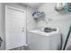 Convenient laundry room includes a modern washer and dryer with built-in shelving at 1028 Orange Cosmos Blvd, Davenport, FL 33837